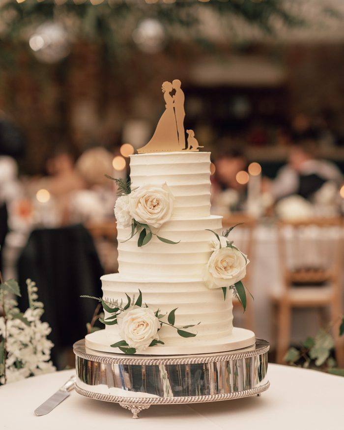Textured white buttercream three-tier wedding cake with ivory roses by Catherine Scott